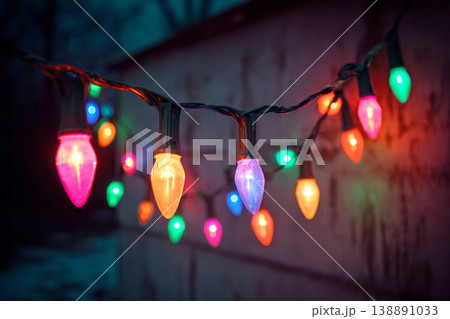 Bright colored garland lights shine vibrantly, creating a festive atmosphere for a celebration at night. The lights twinkle and glow in a warm indoor setting 138891033