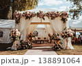 A wedding tent is set up in a garden. It features floral decorations and a seating area. Guests can gather here for the celebration during the afternoon light 138891064