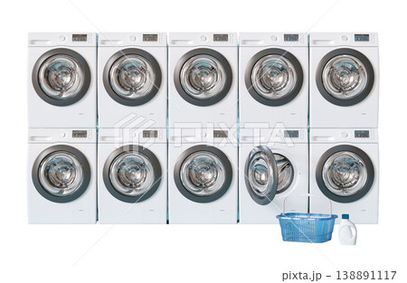 A row of washing machines in a public laundry. A blue basket sits next to one of the machines, and a bottle of laundry detergent is nearby 138891117
