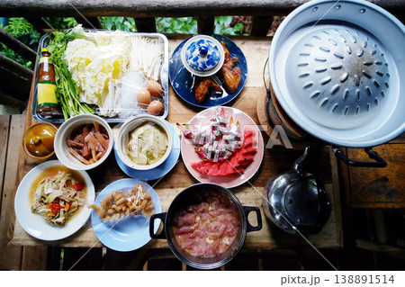Top view of Moo Krata set, Thai food and Barbecue set on wooden table on terrace in Thailand Top view of Moo Krata set, Thai food and Barbecue set on wooden table on terrace in Thailand 138891514