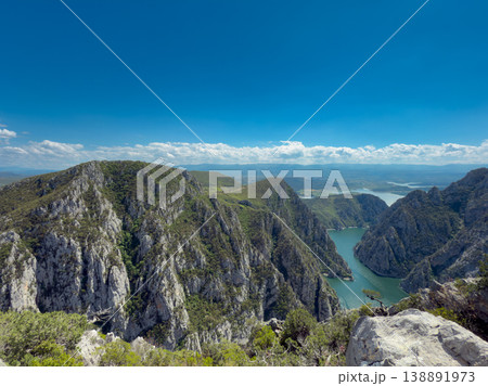 Mountain river in a canyon against a background of green forest and blue sky Mountain river in a canyon against a background of green forest and blue sky 138891973