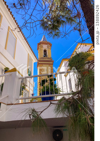 A bright white street lined with colorful flower pots and blooming plants creates a charming Mediterranean scene in Estepona, Spain A bright white street lined with colorful flower pots and blooming plants creates a charming Mediterranean scene in Estepona, Spain 138892426