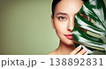 Close up woman face with green exotic leaf 138892831