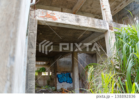 Abandoned Concrete Structure with Exposed Beams and Overgrown Grass Taichung 138892836
