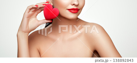 Young beautiful woman with heart shaped gift 138892843