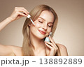 Young beautiful woman applying face serum 138892889
