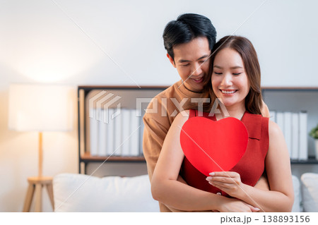 Portrait happy asian couple holding heart card celebrating Valentine's Day or anniversary. Portrait happy asian couple holding heart card celebrating Valentine's Day or anniversary. 138893156