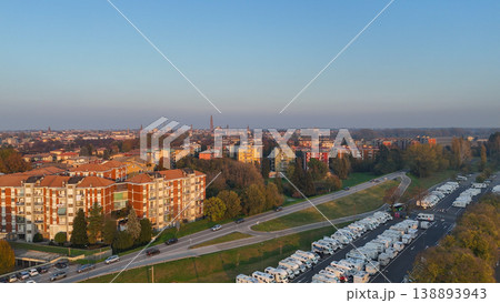 Piazzale Azzuri d'Italia in Cremona, Italy, managing an urban camper van parking area for tourists, aerial view Piazzale Azzuri d'Italia in Cremona, Italy, managing an urban camper van parking area for tourists, aerial view 138893943