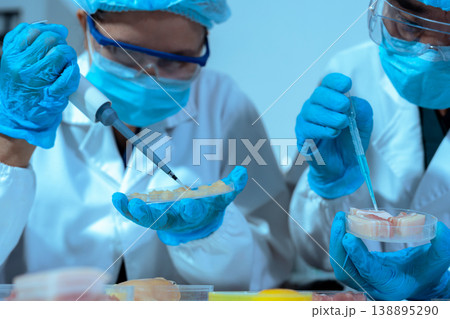 Team Food Safety Scientists Testing Meat Samples in Laboratory for Contamination and Chemical Residue Analysis. Team Food Safety Scientists Testing Meat Samples in Laboratory for Contamination and Chemical Residue Analysis. 138895290