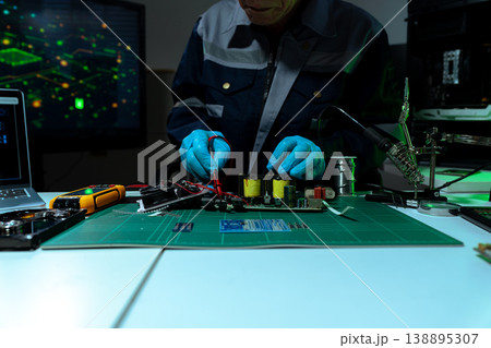 Close up of Technician measuring voltage electronic circuit board, Service after sale fix electric equipment. 138895307