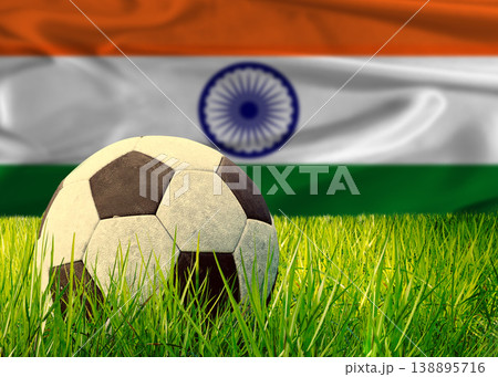 Soccer ball on the grass with India flag in the background. Soccer ball on pitch against Indian flag in the background Soccer ball on the grass with India flag in the background. Soccer ball on pitch against Indian flag in the background 138895716