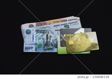 Russian rubles and plastic bank cards on a black background 138896136
