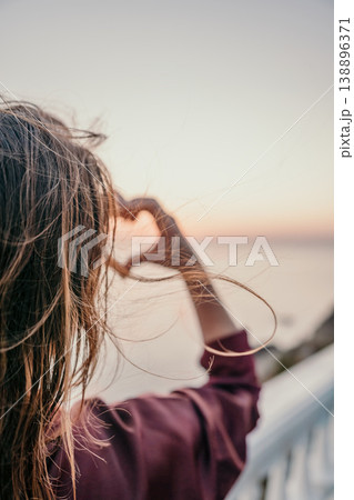 Heart sunset horizon Woman makes a heart symbol with her hands overlooking the sea during a beautiful golden hour Heart sunset horizon Woman makes a heart symbol with her hands overlooking the sea during a beautiful golden hour 138896371
