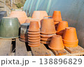 Clay terracotta pots arranged near a greenhouse. 138896829