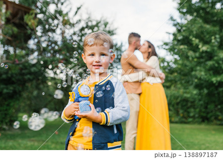 Little Boy Playing With Soap Bubbles Outdoors Little Boy Playing With Soap Bubbles Outdoors 138897187