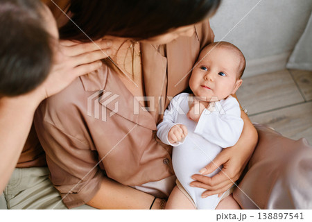 Cute Newborn Baby Lying In Mothers Arms 138897541