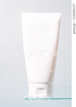 White cosmetic tube on glass shelf with copy space White cosmetic tube on glass shelf with copy space 138899157