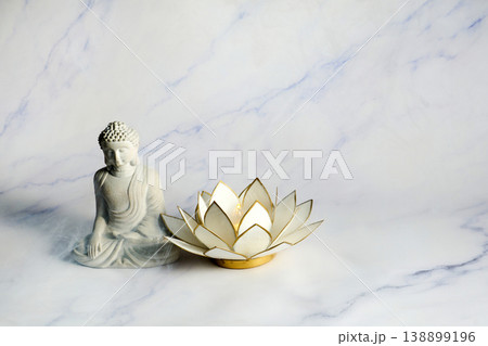 Vesak day. Buddha statue and lotus candle for meditation and wellness Vesak day. Buddha statue and lotus candle for meditation and wellness 138899196