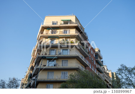Corner residential apartment building with balconies under clear blue sky in Barcelona Spain 138899967