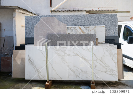 Marble and granite stone slabs display in outdoor construction materials yard 138899971