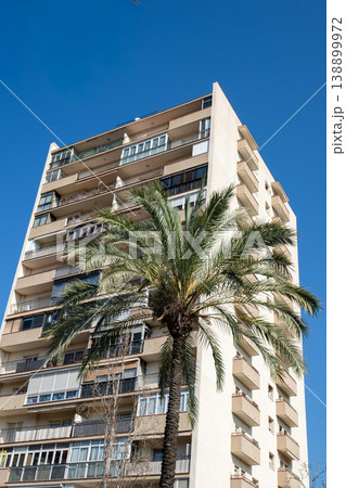 Modern apartment building with palm tree against clear blue sky in Barcelona 138899972