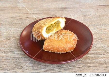 donut bread filling chicken curry half cut on plate 138902011