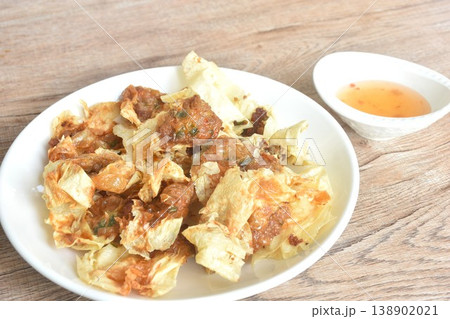 crispy fried dumpling tofu skin stuffed chop pork and shrimp dipping sweet plum sauce on bowl 138902021