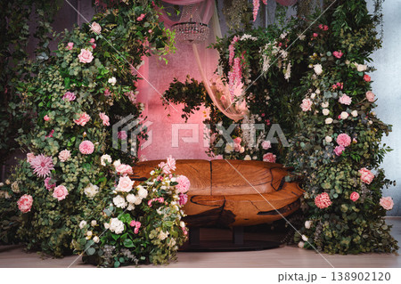 Wide shot of an interior photo studio with floral decorations and wooden furniture Wide shot of an interior photo studio with floral decorations and wooden furniture 138902120