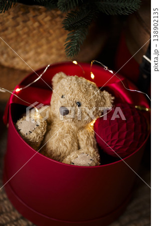 Vintage Christmas decor with red chest decorative drum and toys on jute rug in cozy interior Vintage Christmas decor with red chest decorative drum and toys on jute rug in cozy interior 138902135