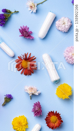 Colorful flowers and feminine hygiene products on a blue background Colorful flowers and feminine hygiene products on a blue background 138902166