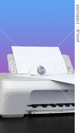 Printer in use with paper coming out and a watch nearby on a simple background Printer in use with paper coming out and a watch nearby on a simple background 138902269