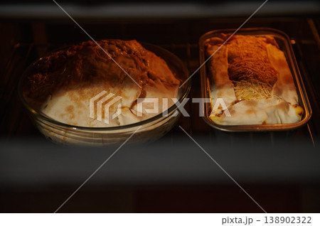Homemade Pies and Loaf Baking in Oven With Golden Pastry and Melted Cheese Homemade Pies and Loaf Baking in Oven With Golden Pastry and Melted Cheese 138902322