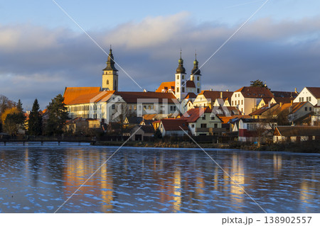 Telc cityscape reflecting on a frozen lake at sunset 138902557