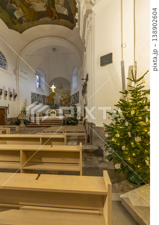 Church interior with Christmas trees and glowing cross 138902604