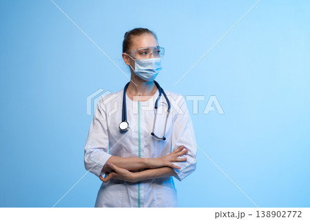 Female medical professional wearing mask and goggles Female medical professional wearing mask and goggles 138902772