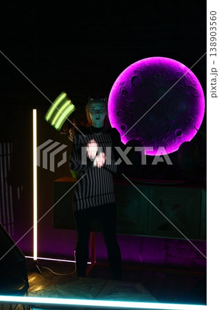 Street character hidden in neonlit urban setting at night 138903560