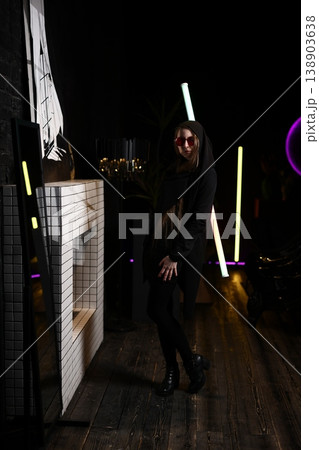 Caucasian female posing with bright neon lights and stylish sunglasses Caucasian female posing with bright neon lights and stylish sunglasses 138903638