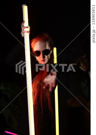 Immersive installation featuring strikingly styled neon performer 138903651