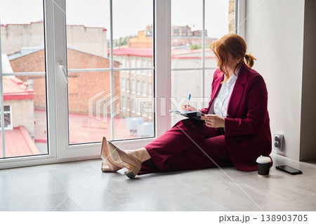 Person in sophisticated clothing maps out strategic steps thoroughly Person in sophisticated clothing maps out strategic steps thoroughly 138903705
