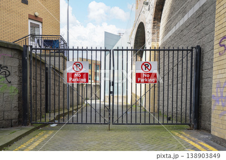 a gate with no parking signs a gate with no parking signs 138903849