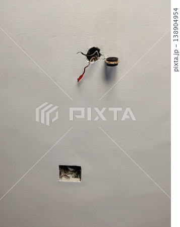 Ceiling fan mount frame with exposed wire and wrong hole showing poor electrical work Ceiling fan mount frame with exposed wire and wrong hole showing poor electrical work 138904954