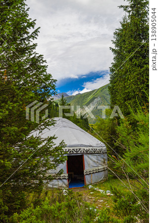 Traditional Kyrgyz yurt along serene pathway in mountains of Kyrgyzstan at summer day 138905044