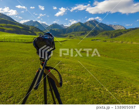 Serene mountain landscape with meadow and clouds in Kyrgyzstan Serene mountain landscape with meadow and clouds in Kyrgyzstan 138905097