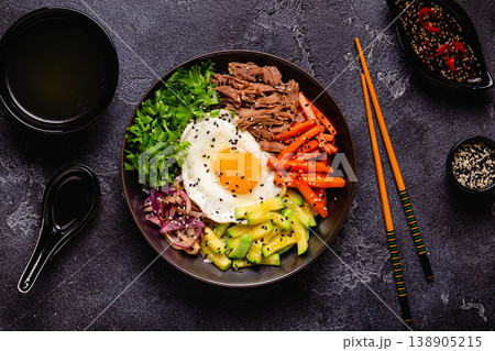 Traditional Korean dish Bibimbap: rice with vegetables beef and egg. Traditional Korean dish Bibimbap: rice with vegetables beef and egg. 138905215