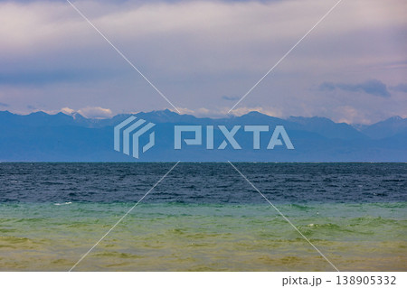 Majestic landscape of mountains and calm water of Issyk-Kul lake in Kyrgyzstan Majestic landscape of mountains and calm water of Issyk-Kul lake in Kyrgyzstan 138905332