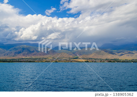Serene Town by Issyk-Kul lake with Majestic Mountains in Kyrgyzstan Serene Town by Issyk-Kul lake with Majestic Mountains in Kyrgyzstan 138905362
