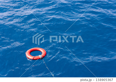 Life preserver and rope floating in open ocean water 138905367