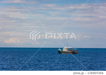boat in serene mountain lake Issyk-Kul setting boat in serene mountain lake Issyk-Kul setting 138905368