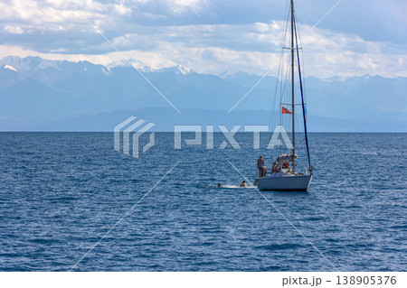 Group of adults sailing and swimming on Issyk-Kul lake in Kyrgyzstan 138905376