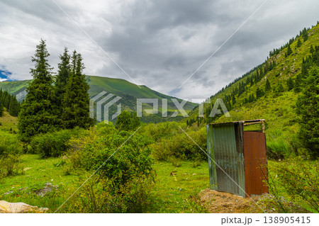 Outdoor toilet structure in serene mountain landscape in Kyrgyzstan Outdoor toilet structure in serene mountain landscape in Kyrgyzstan 138905415